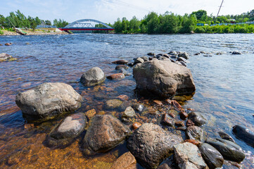 A fast river under a blue sky.