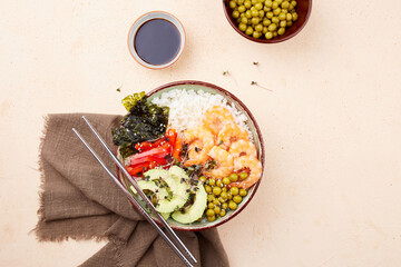 Poke bowl with shrimp, rice, avocado, pepper, green peas, nori and micro greens. Hawaiian diet dish with seafood 