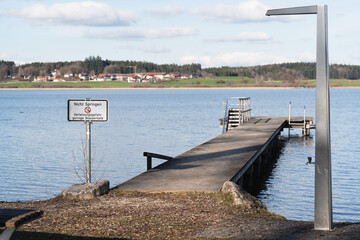 pier in the lake with a sign saying 