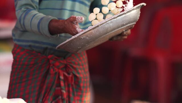 Art of making Rasgulla, a delightful Indian dessert made from milk solids, deep-fried to golden perfection and soaked in fragrant sugar syrup. Vibrant, aromatic, tempting. A feast for the senses