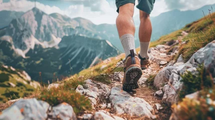 Foto op Canvas Trekking. Men's legs with sports shoes and a backpack run along a mountain path. Travel and camping adventure lifestyle with outdoor activity  © Ilmi