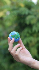 Environment Earth Day In the hands holding green earth on Bokeh green Background, Saving environment, and environmentally sustainable. Save Earth. Concept of the Environment World Earth Day