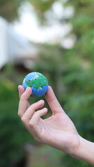 Environment Earth Day In the hands holding green earth on Bokeh green Background, Saving environment, and environmentally sustainable. Save Earth. Concept of the Environment World Earth Day