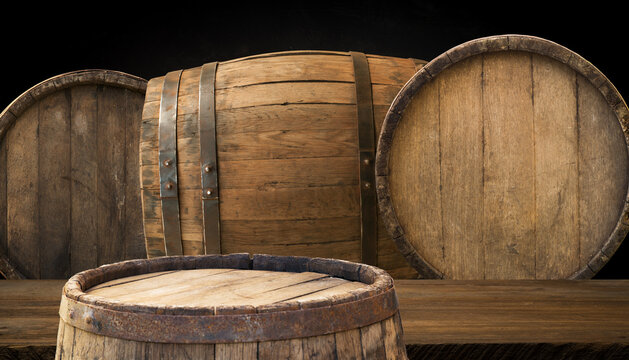 Oktoberfest beer barrel and beer glasses with wheat and hops on wooden table. High quality photo