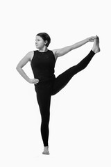 Fototapeta na wymiar Utthita Hasta Padangusthasana, Ashtanga yoga Side view of woman wearing sportswear doing Yoga exercise against white background. Vertical image.