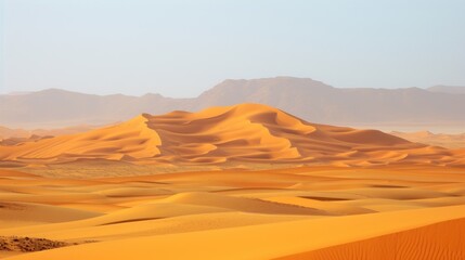 a desert scene with mountains in the distance and sand dunes in the foreground in the foreground, and a hazy sky in the background.