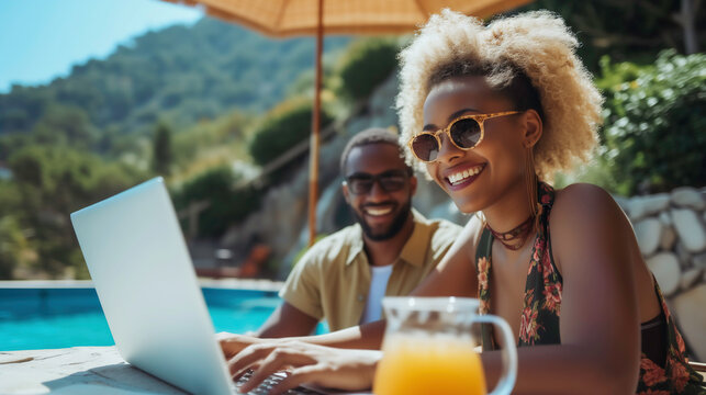Smiling couple enjoying beach vacation and working on laptop and relaxation in work and life with embracing happiness by the sea, Travel and work concept.