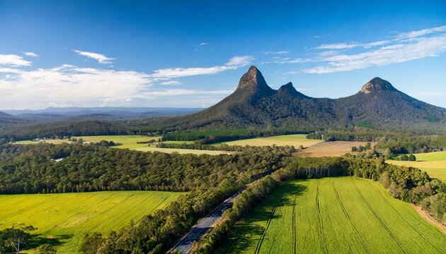 glass house mountains sunshine coast queensland australia showing blue sky mountains paddocks farming land and forests
