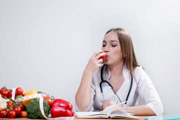Professional nutritionist looking at the fruit and vegetables on the consultation of patient