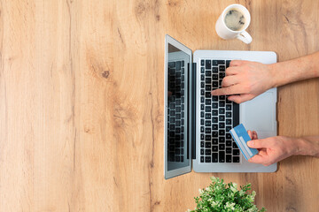 Top view of male hands making an online payment