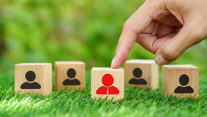 Hands choosing man people icons on wooden cube. Personal auditing or CRM concept, Human resource...