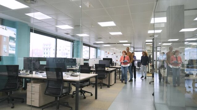 Happy diverse colleagues entering creative workspace