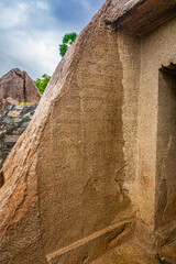 An Ancient Tamil Letters Inscription or Vattezhuthu or grantha script at near Tiger Cave is a rock-cut Hindu temple, Rockcut Shiva Temple (Excavated) located in the hamlet of near Mahabalipuram.