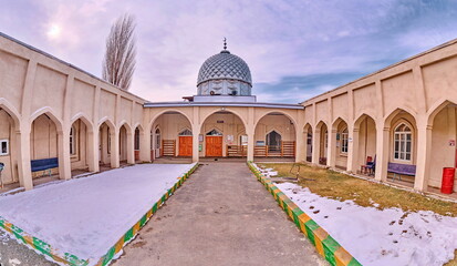 The inner courtyard of the old mosque in the city of Razzakov, Kyrgyzstan.