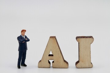 miniature figurines of businessmen with artificial intelligence abbreviation