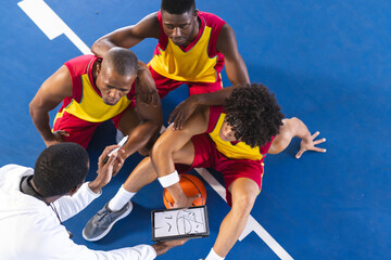 Diverse basketball team strategizes during a timeout
