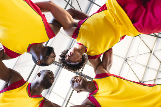 Diverse basketball team in a huddle - Powered by Adobe