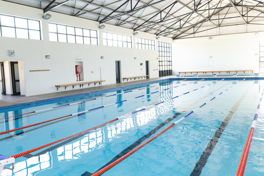 An indoor swimming pool awaits swimmers, with copy space