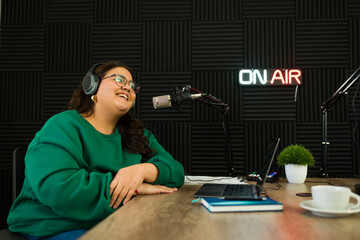 Happy podcast host smiling while recording a podcast episode