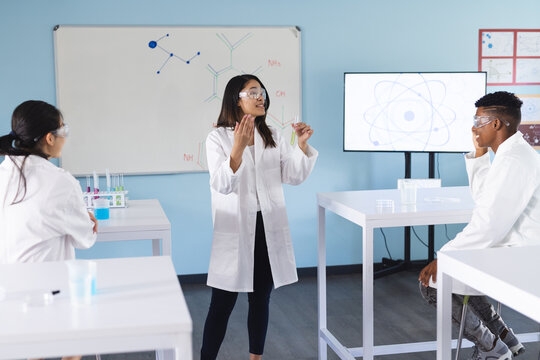 Teenage Asian girl presents to students in a school lab