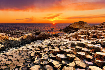 Beautiful rock formations of Giants Causeway with vibrant sunset, Northern Ireland