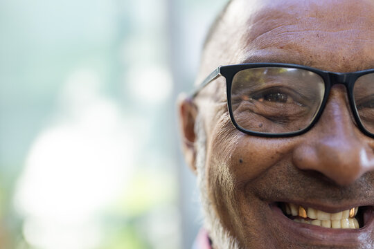 Senior close-up of a smiling biracial man outdoors, with copy space