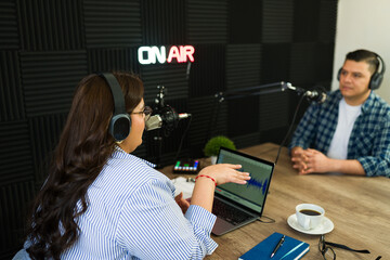 Podcast host talking with a talk show guest in the studio