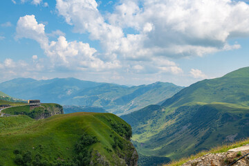 Fototapeta premium Celestial Wilderness: Blue Sky Over Vast Green Mountains