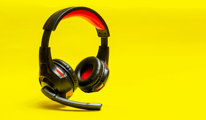 Wireless Over-Ear full size Headphones, Black leather isolated on yellow background .