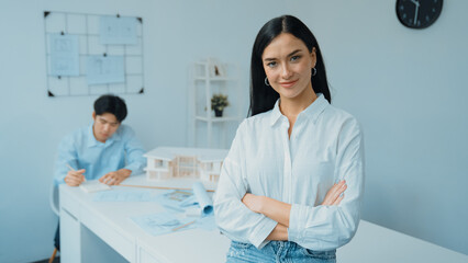 Closeup of female professional architect engineer cross arms with confident while skilled coworker...