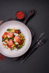 Delicious juicy salad with salmon, tomatoes, cucumber, herbs, pumpkin seeds