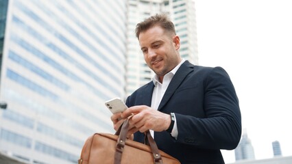 Caucasian business man checking mobile phone and looking report sales from marketing team while...