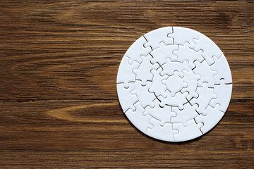 Circular Jigsaw Puzzle on a Wooden Table