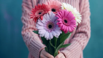 Fotobehang women holding bouquet of 3 gerbera flowers in pink, purple and white color with dark blue blur background © sundas