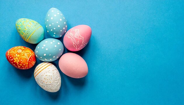 colorful handcrafted easter eggs on blue backdrop minimalistic concept top down perspective text space on card copy space image place for adding text or design