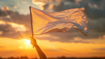 Person holding up a white flag at sunset, concept of peace - obrazy, fototapety, plakaty
