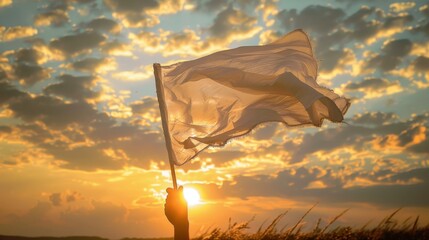 Person holding up a white flag at sunset, concept of peace - obrazy, fototapety, plakaty