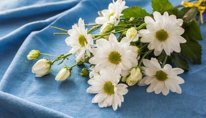 bouquet of white flowers on blue fabric