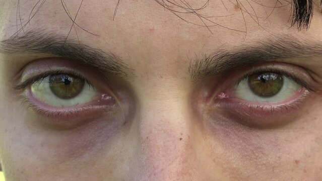 young man with angry look: serious and aggressive look: in the closeup footage
