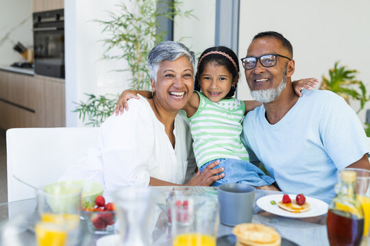 Biracial grandparents enjoy breakfast at home