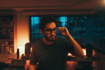 Man wearing glasses in a warm room
