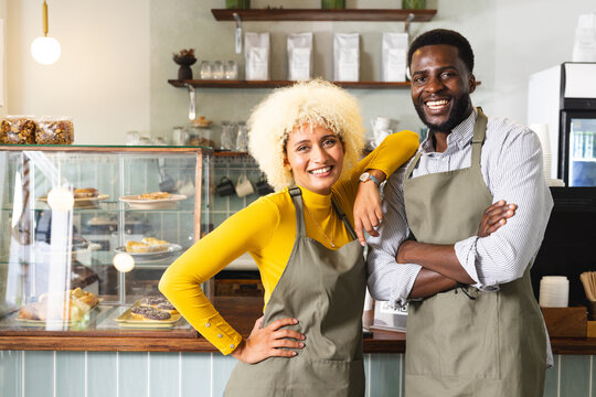 Confident entrepreneurs pose in a cozy cafe, with copy space