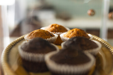 Freshly baked muffins are displayed on a plate, tempting viewers