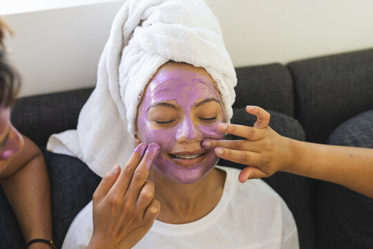 Two people enjoy a skincare routine at home, applying face masks