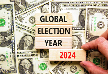 Global election year 2024 symbol. Concept words Global election year 2024 on beautiful block. Beautiful dollar bills background. Voter hand. Business Global election year 2024 concept. Copy space