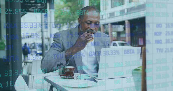 Stock market data processing against african american senior man having a snack while using laptop - Powered by Adobe