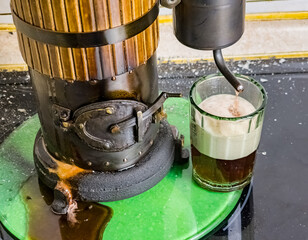 The process of distilling wine at a mini distillery using wood. Volume 400 ml.