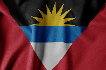 National Flag on Textured Fabric Background. Silk textured flag, realistic wave and flag look. AG  Flag of Antigua and Barbuda
