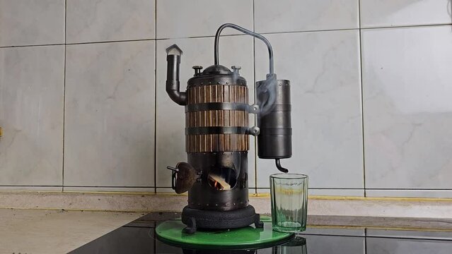 The process of distilling wine at a mini distillery using wood. Volume 400 ml.
