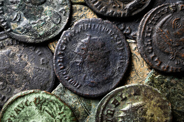 Pile of Ancient Roman coins close-up, pattern of old bronze money with emperors portraits, top view...